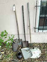Overall lot showing shovels, owl, dustpan, pottery jar