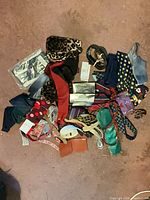 Pile view showing neckties, belts, wallet, accessories