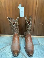 Front view of brown leather cowboy boots showing snip toe and shaft stitching