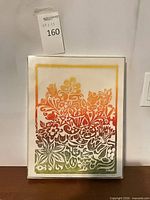 Full view of framed linocut print showing floral design and frame