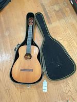 Guitar in open hard case, full view