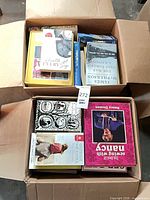 Top-down view of both boxes showing multiple book spines and covers