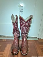 Front view of burgundy ostrich cowboy boots showing toe shape and decorative stitching