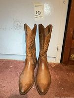 Front view of both brown Loblan cowboy boots standing upright