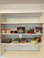 Full view of shelving showing majority of tins on two shelves