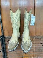 Full view of both boots on rack showing shaft color and stitching