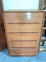 Front view showing five drawers and overall design