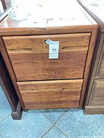 Front view of oak veneer 2-drawer file cabinet