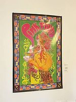 Full view of framed Pink Floyd poster hanging on wall