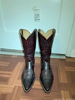 Front view of both burgundy leather cowboy boots standing upright