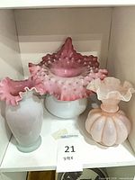 Front view of all three opalescent pink and white vases
