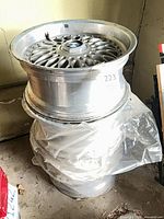 Stack of BMW alloy wheels showing multi-spoke design and center cap