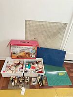 Group shot of fabric mover box, mats, trays of thread and ribbons