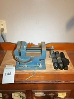 Bench vise on board with hardware and spare handles