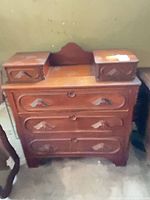 Front view showing dresser with three large drawers and two small raised compartments