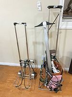 Both folding metal frames, one with tool bag attached