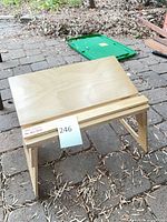 Front angle showing desk top tilted and foldable legs