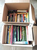 Two open boxes filled with mixed books