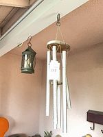 Wind chime and lantern hanging from beam