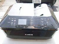 Front and top view showing Canon branding, control panel and overall condition