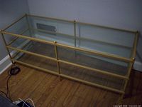 Full view of rectangular gold-tone metal and glass coffee table