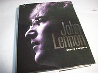 Front view of the John Lennon Unseen Archives hardcover book showing dust jacket design