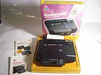 Boxed Kodak 980L Kodamatic instant camera kit with manuals and strap