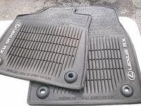 Stacked Lexus RX rubber floor mats showing logos, ridges, and grommets