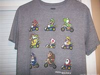 Front view of grey T-shirt with Mario Kart characters and logo