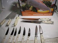 Box and entire set laid out showing variety of knives and honing steel