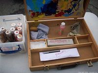 Overall lot showing paint box open and plastic bin of paints