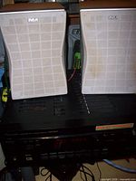 Front view of Pioneer receiver with two RCA speakers positioned on top