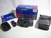 Front view showing camera, box, manual, case and accessories