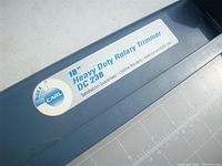 Close-up of brand label indicating 18" heavy duty rotary trimmer model DC 238 by Carl
