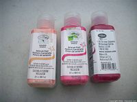 Front labels of two paint bottles showing brand, line and capacity