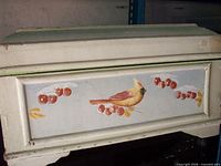 Front view showing painted cardinal motif on storage box