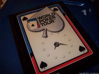 Front view of rectangular World Poker Tour wall clock showing design and hands