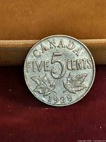 Reverse side showing denomination, maple leaves, date