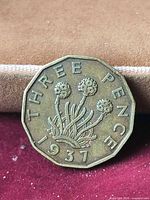 Reverse of 1937 threepence showing thrift plant and denomination