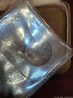 Reverse of 1937 Canada 1-cent coin in plastic holder