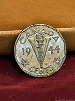 Reverse of 1944 Victory nickel showing V and torch design