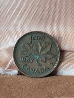 Reverse showing 1 cent, 1947 date, maple leaf twig, legend Canada