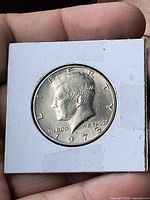 Obverse of 1973 Kennedy half dollar in holder