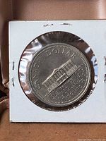 Reverse of the 1973 PEI dollar coin inside holder