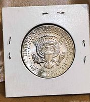 Reverse of 1974 Kennedy half dollar in 2x2 holder showing Presidential Seal design