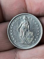 Obverse showing Helvetia standing with shield and stars