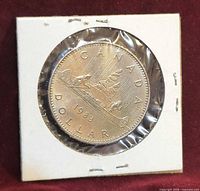 Reverse of 1983 Canada nickel dollar in 2×2 holder