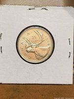 Reverse side showing caribou design, 25 CENTS denomination, and 1990 date