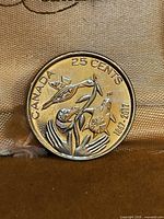 Reverse side showing hummingbird and flowers, inscriptions CANADA, 25 CENTS, 1867-2017