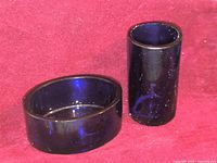 Oval and cylindrical cobalt blue glass salt cellars side by side
